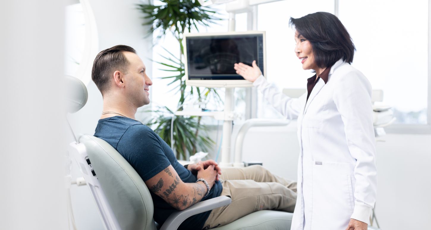 marina del rey dentist showing patient model a screen