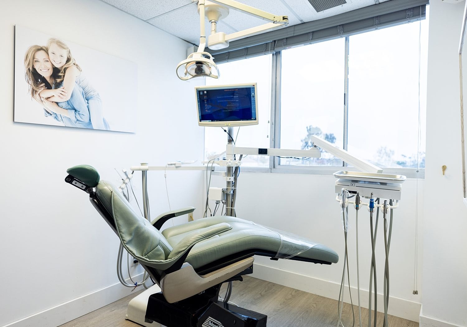 Yeo Family Dental examination room with chair and monitor.